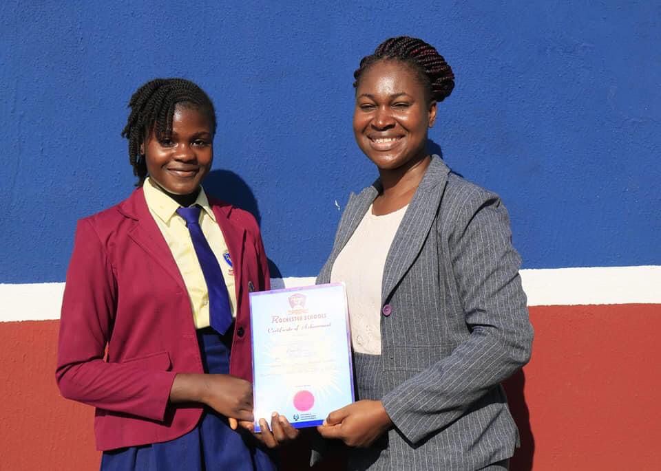 Rochester School student receiving a certificate