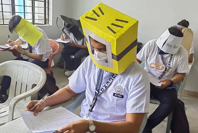 Students wearing anti-cheating hats