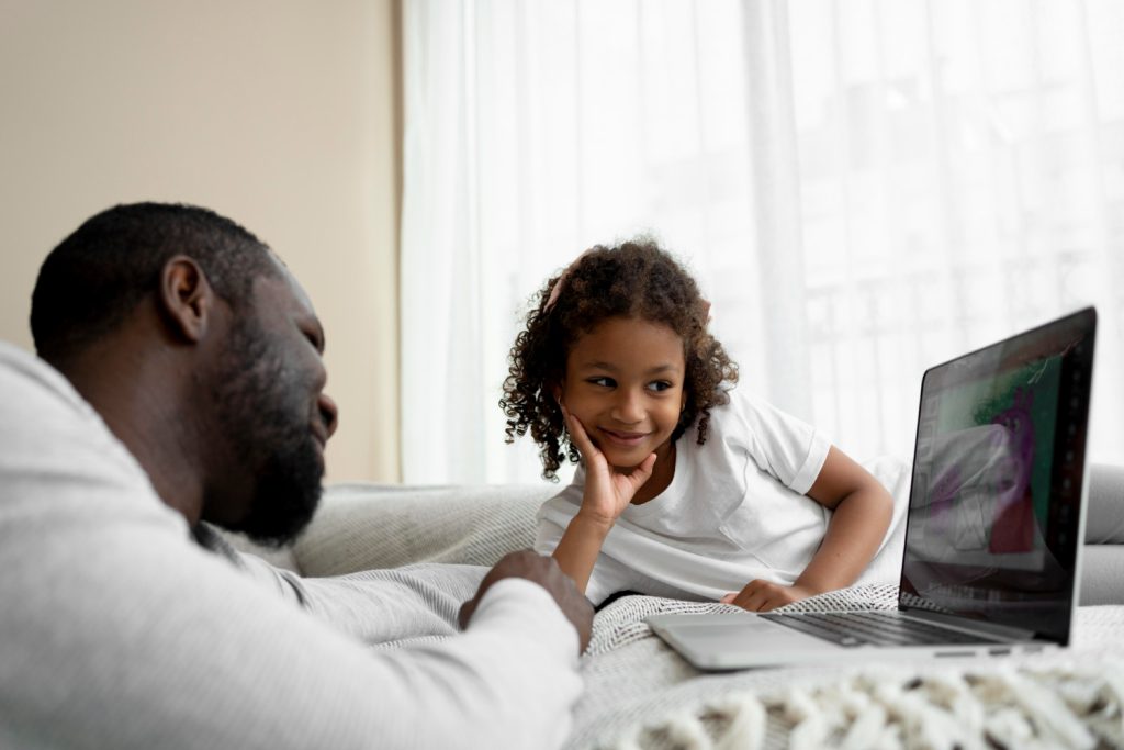 Father and daughter looking at a laptop
